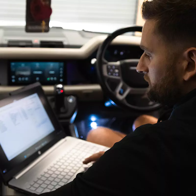 technician carrying out some diagnostic and coding work on a land rover defender