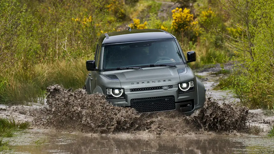 defender octa wading through water